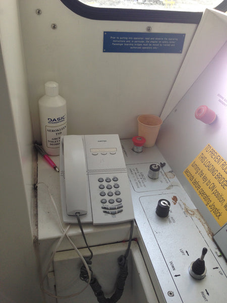 Jet bridge: cup, cleaning product, pen
